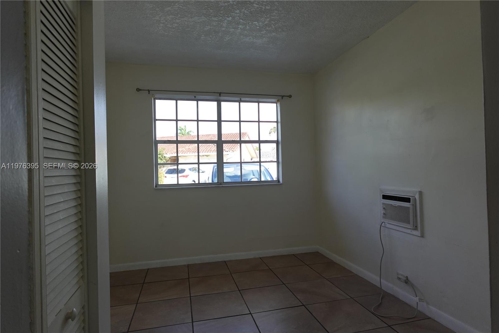 11262 Southwest 74th Street Miami, FL 33173 - Photo 4 of 19 an empty room with a empty space and windows