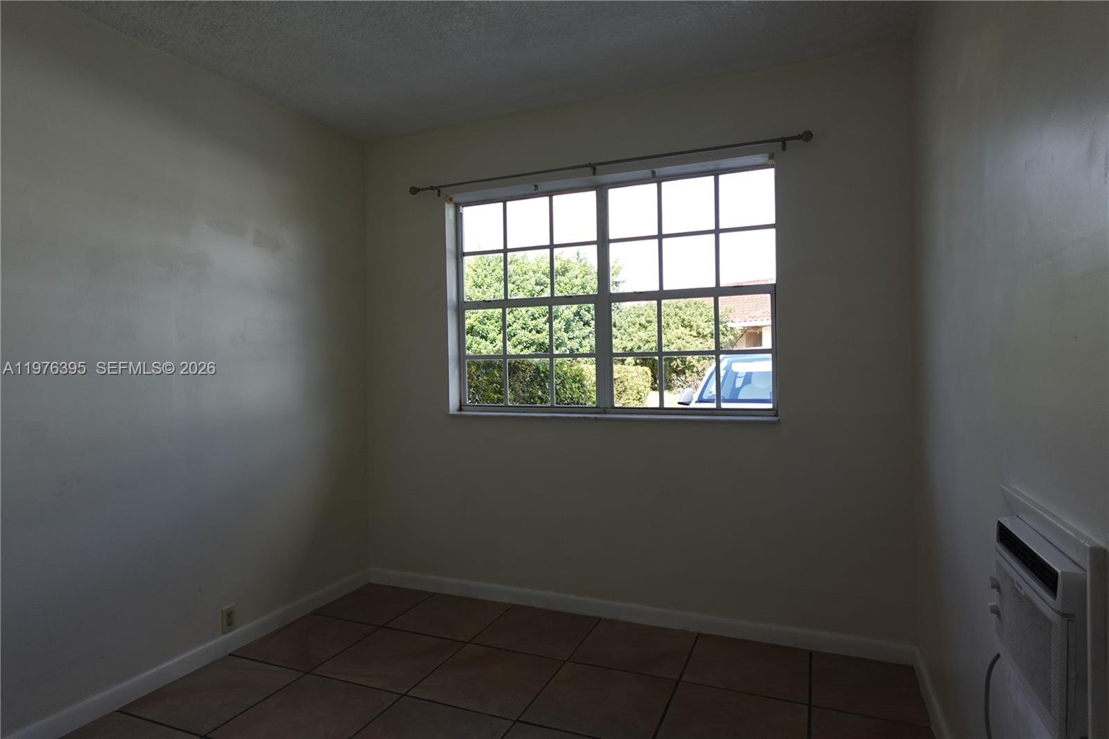 11262 Southwest 74th Street Miami, FL 33173 - Photo 8 of 19 an empty room with a window
