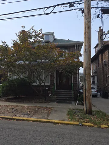 a view of a house with a tree