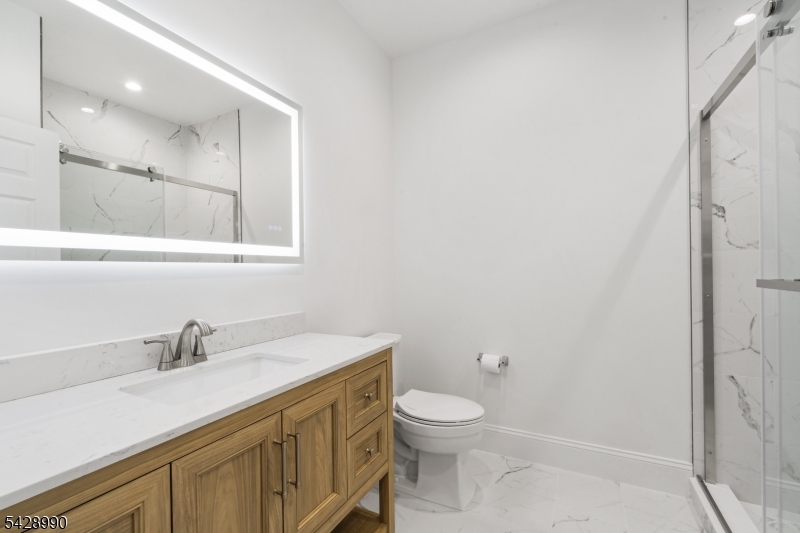 13 Main Street, Unit 3 Sparta, NJ 07871 - Photo 5 of 9 a bathroom with a sink a toilet and shower