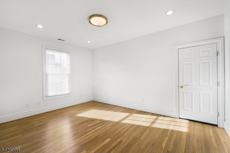 13 Main Street, Unit 3 Sparta, NJ 07871 - Photo 7 of 9 a view of empty room with wooden floor and fan