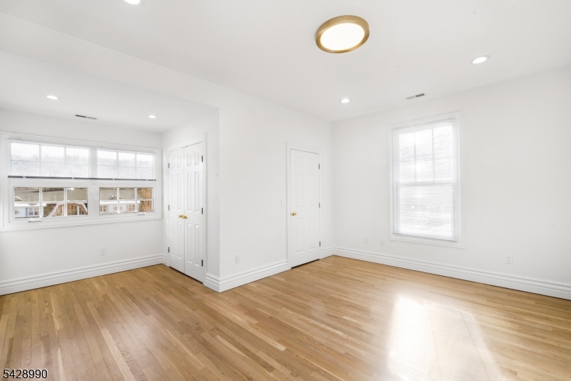 13 Main Street, Unit 3 Sparta, NJ 07871 - Photo 8 of 9 an empty room with wooden floor and windows
