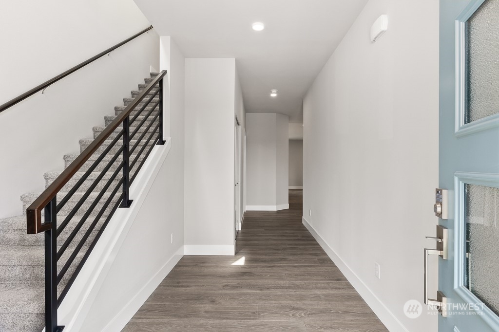 2014 228th Place Southwest, Unit EP 48 Bothell, WA 98021 - Photo 3 of 19 a view of a hallway with wooden floor and staircase