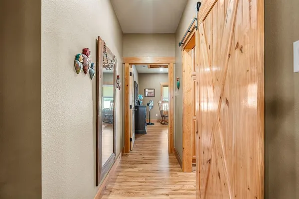 a bathroom with a granite countertop sink a mirror and shower
