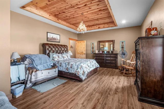 a bed room with a bed a couch and dresser