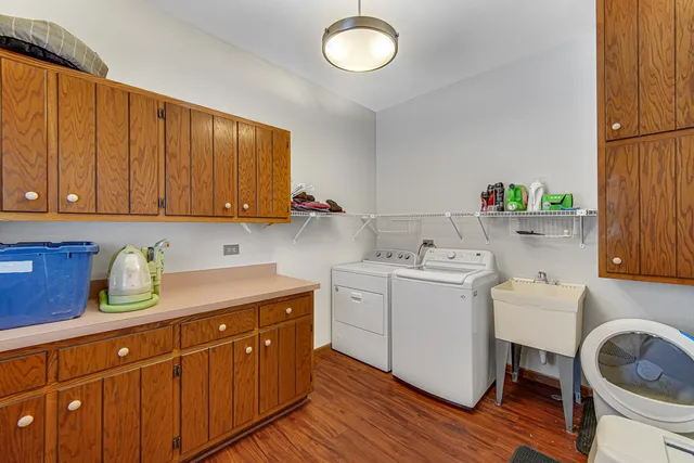 a view of a kitchen filled with furniture and wooden floor