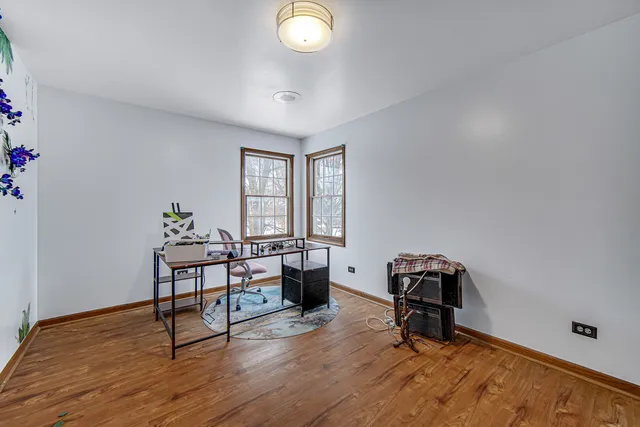 a view of a workspace with furniture and a window