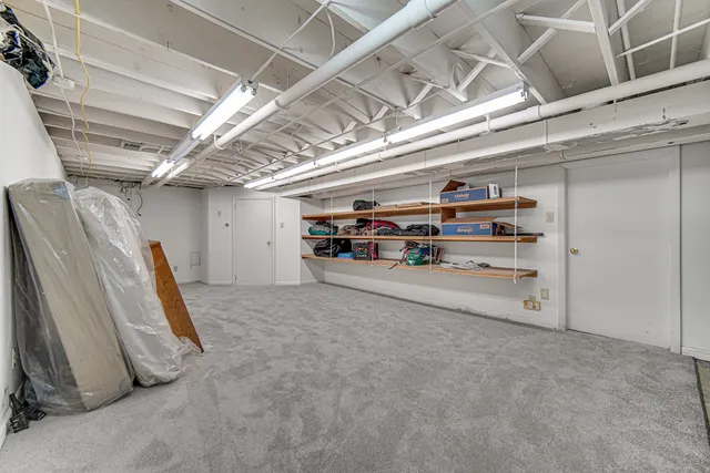 a view of a house with snow on the roadside