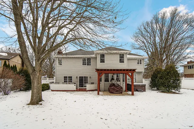 a view of a backyard with a large tree