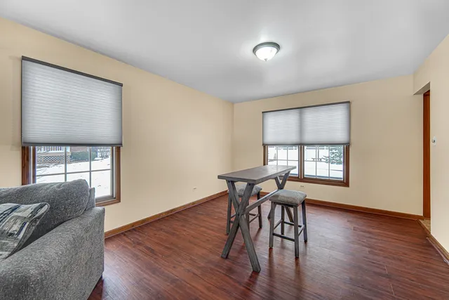 a workspace with furniture window and wooden floor