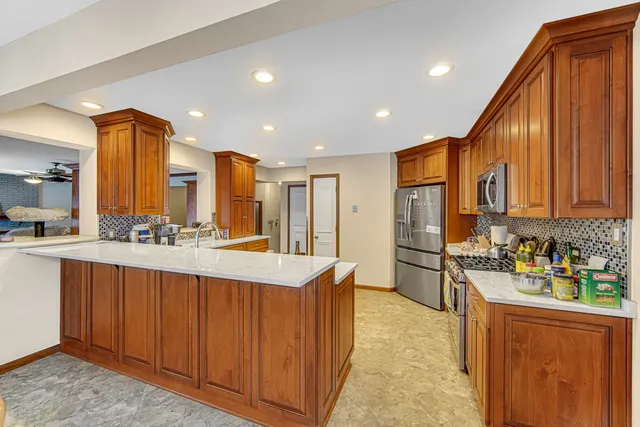 a kitchen with stainless steel appliances granite countertop a sink stove and refrigerator