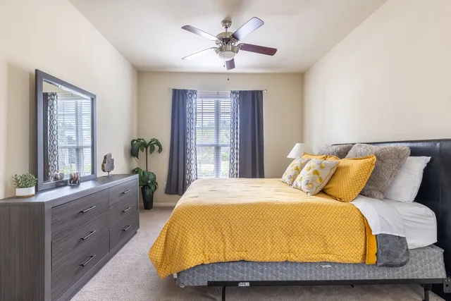 a bedroom with a bed and window