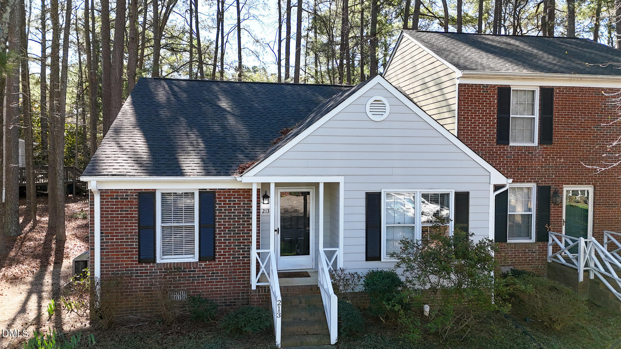 213 Bracken Court Raleigh, NC 27615 - Photo 18 of 20 a view of backyard with large tree and wooden fence