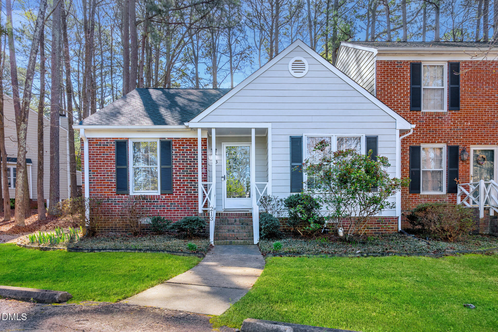 213 Bracken Court Raleigh, NC 27615 - Photo 2 of 20 a front view of a house with a garden and plants