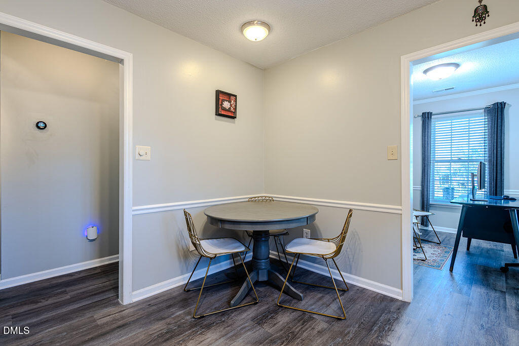 213 Bracken Court Raleigh, NC 27615 - Photo 5 of 20 a view of a room with furniture and wooden floor