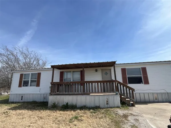 a view of a house with wooden fence