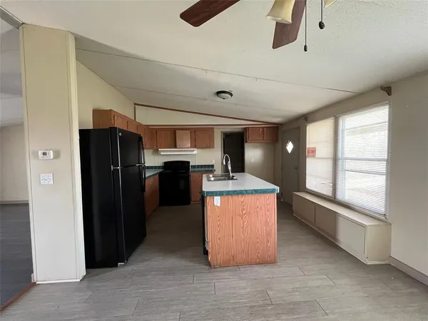 a kitchen with stainless steel appliances granite countertop a refrigerator and a stove