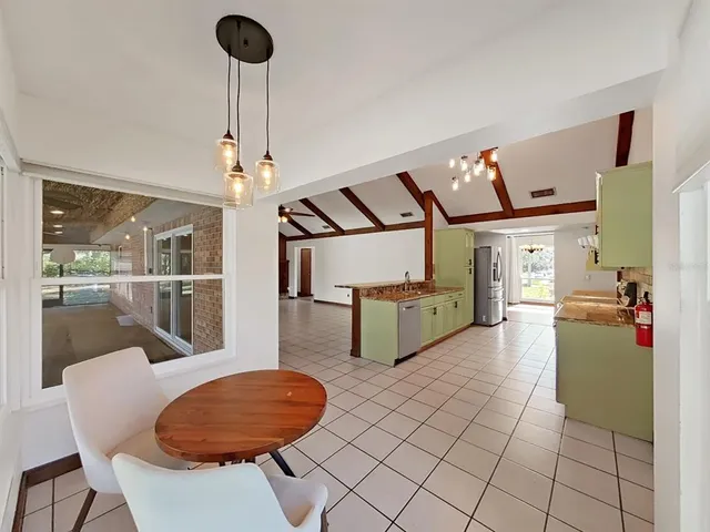 a room with a large window and chandelier