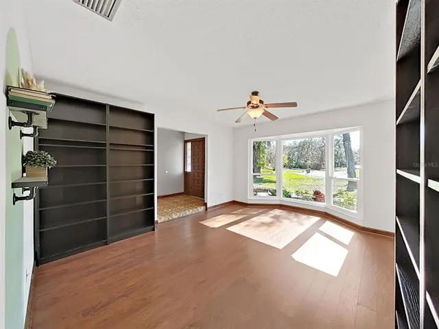 wooden floor in an empty room with a window