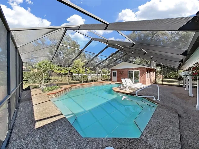 a bathroom with a sink and a large mirror next to a window
