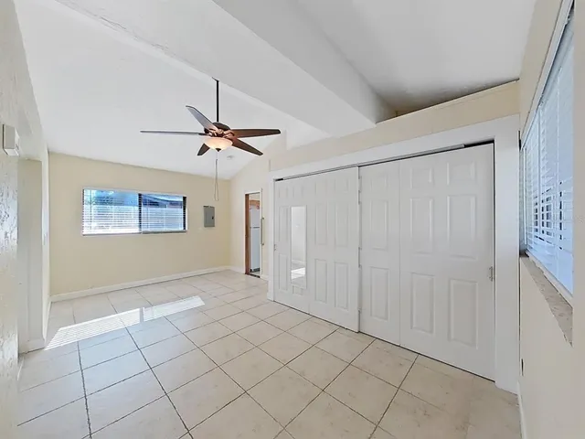 a room with large windows and furniture