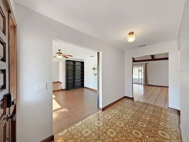 a view of a room with window and wooden floor