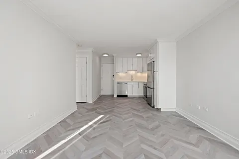 a kitchen with white cabinets and stainless steel appliances