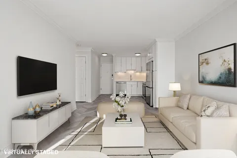 a living room with furniture and kitchen view