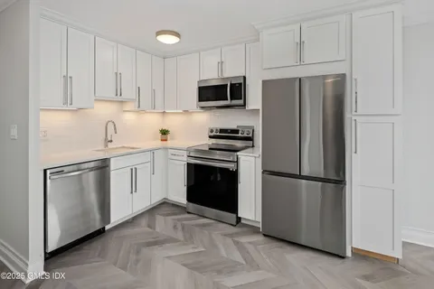 a bedroom with a large bed and a large window