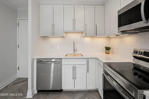a view of a hallway with wooden shelves