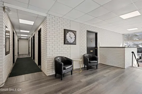 a view of a entryway with furniture and wooden floor