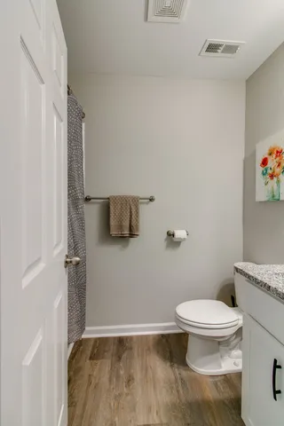 a bathroom with a toilet and a shower