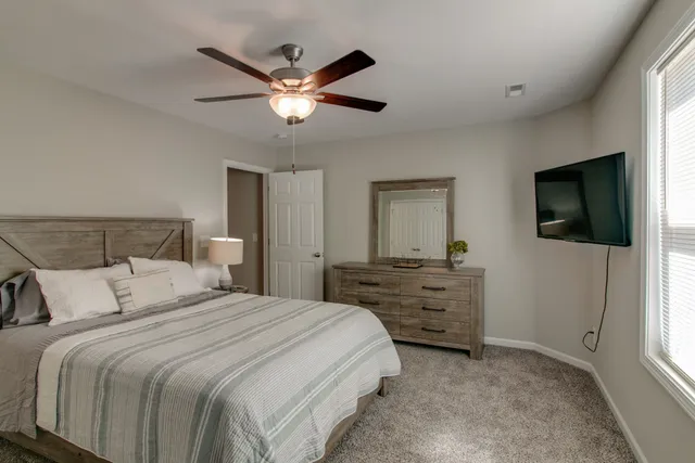 a bedroom with a bed and a flat screen tv