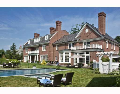 Undisclosed Address Greenwich, CT 06830 - Photo 9 of 10 a front view of a house with a garden and lake view