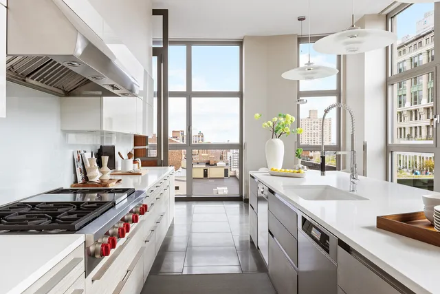 a kitchen with a stove a sink and a refrigerator