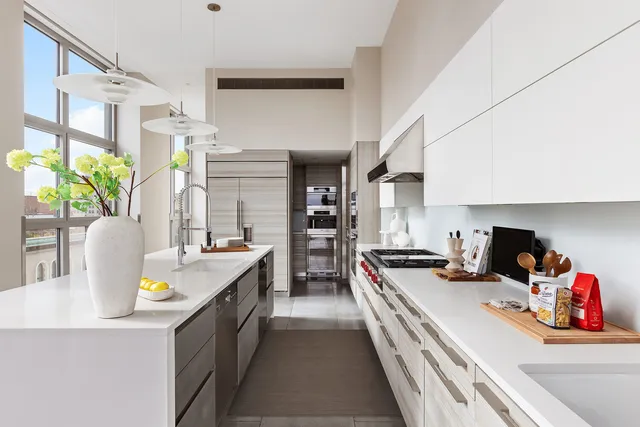 a kitchen with stainless steel appliances a sink a stove and a window