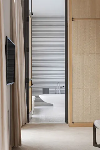 a bed room with a bed and a chair