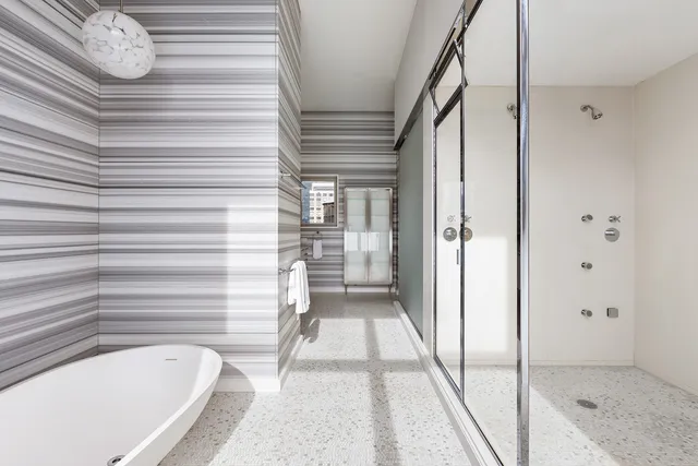 a bathroom with a bathtub and a shower