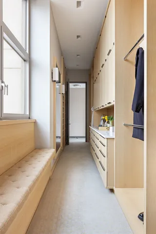 a view of hallway with stairs and furniture