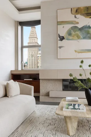 a living room with fireplace furniture and a large window