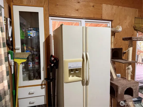 a kitchen with stainless steel appliances a refrigerator and a window