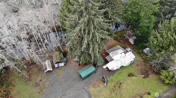 an aerial view of a house with a yard and lake view