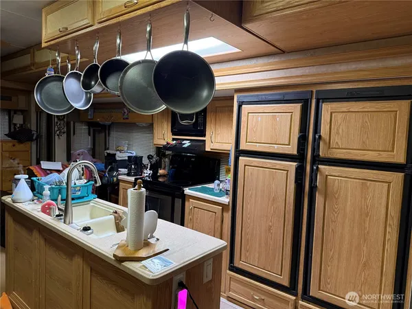 a kitchen with stainless steel appliances granite countertop a sink and cabinets