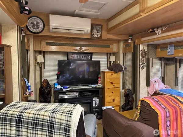 a bedroom with a bed and a tv