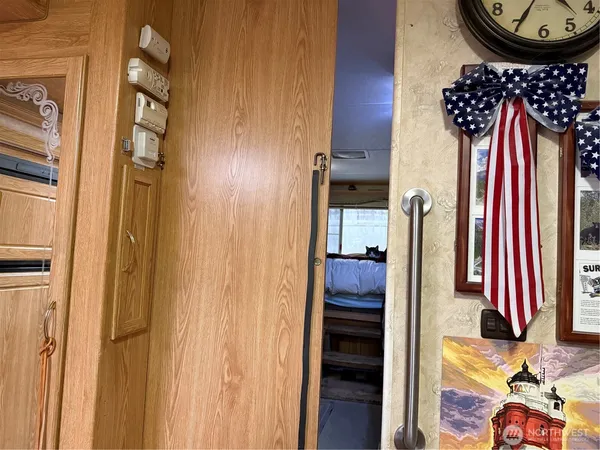 a view of a hallway with a flower pot and a bookshelf