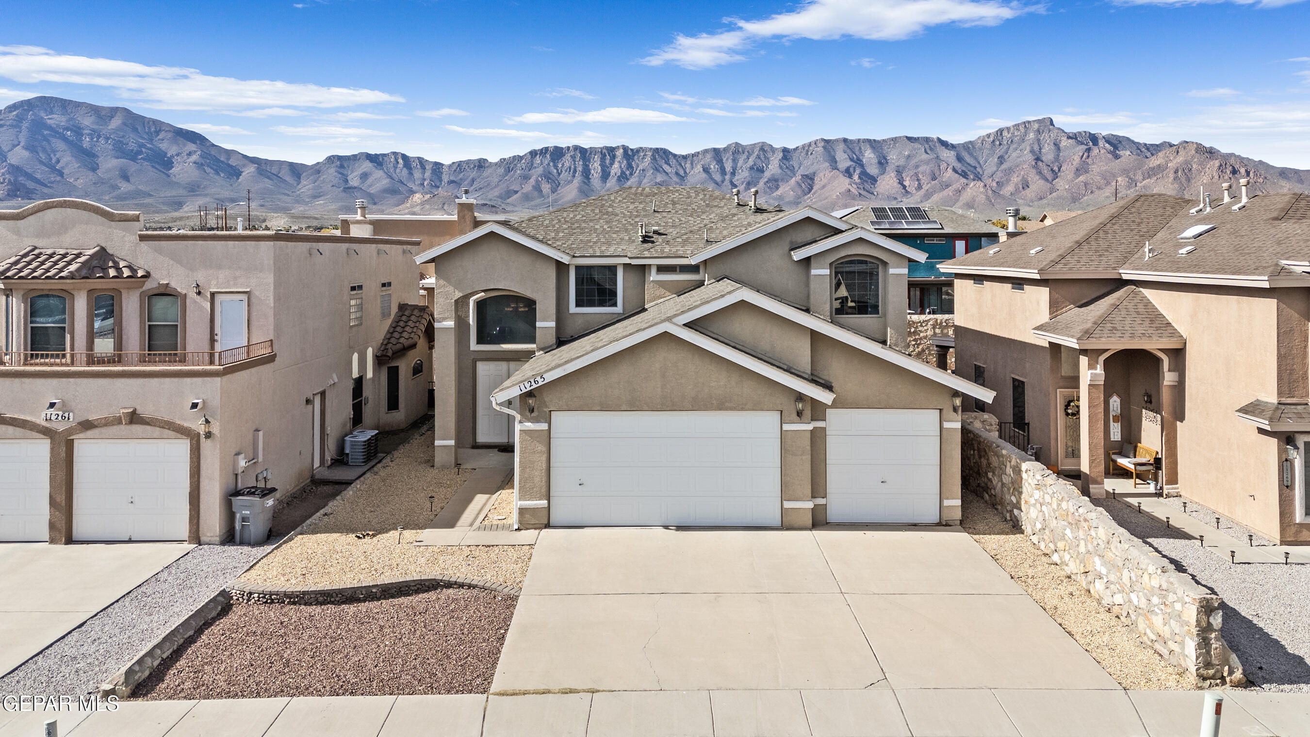 11265 Cattle Ranch Street El Paso, TX 79934 - Photo 1 of 44 a view of a big house with a big yard and large tree