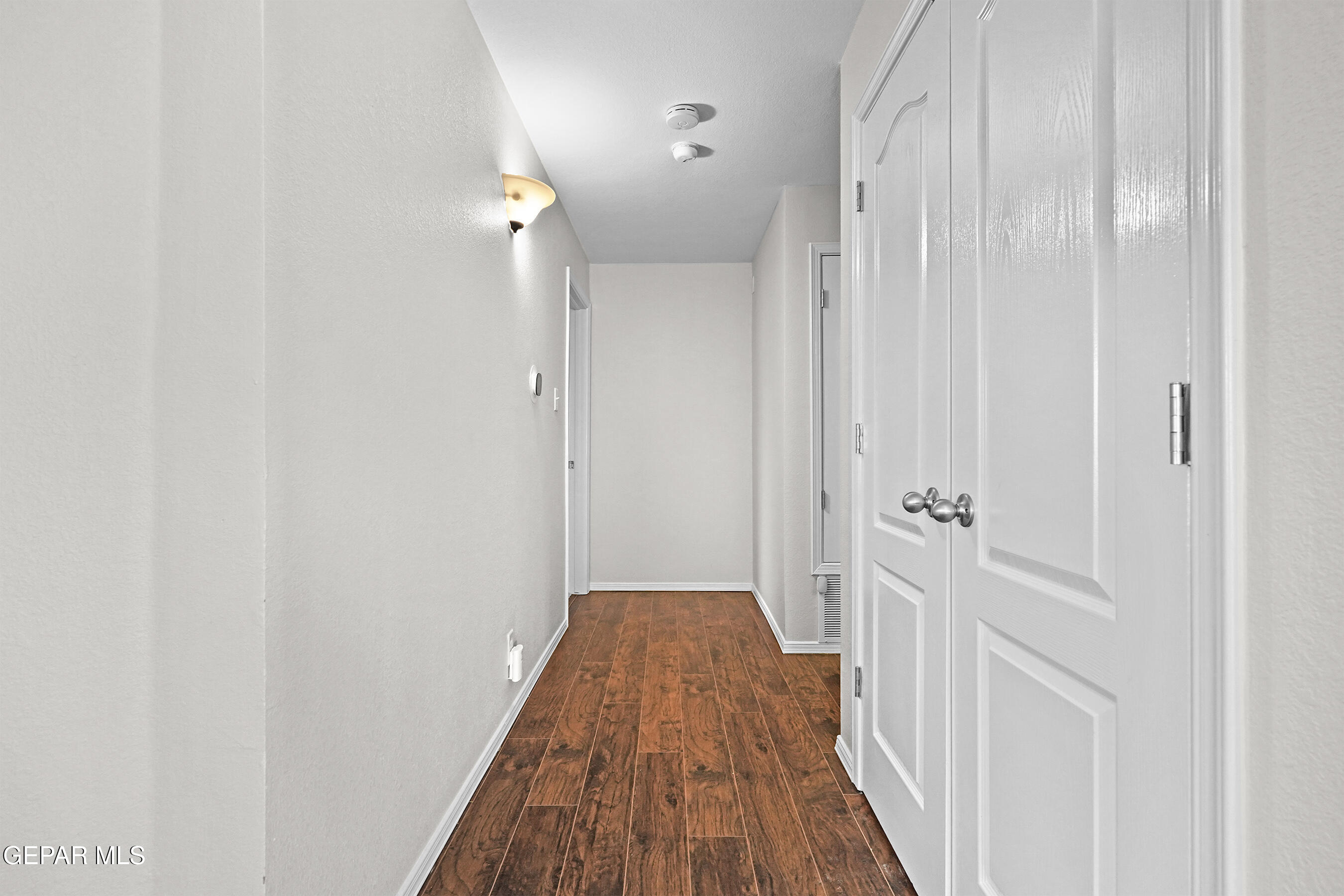 11265 Cattle Ranch Street El Paso, TX 79934 - Photo 17 of 44 a view of a hallway with wooden floor and closet