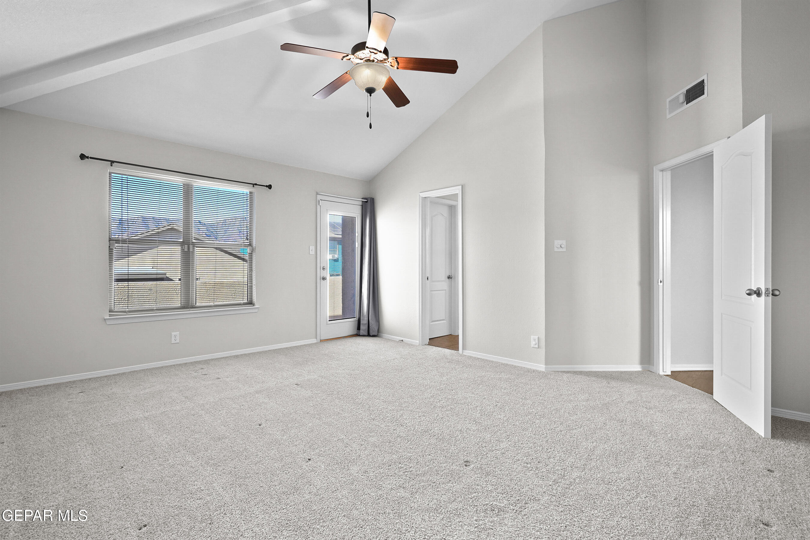 11265 Cattle Ranch Street El Paso, TX 79934 - Photo 4 of 44 an empty room with chandelier fan and windows