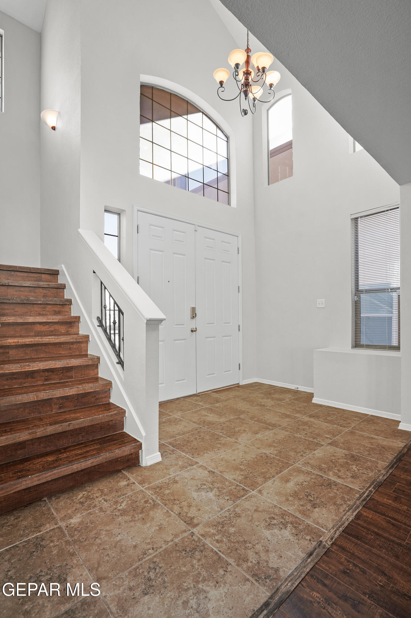 11265 Cattle Ranch Street El Paso, TX 79934 - Photo 5 of 44 a view of an empty room with wooden floor and a chandelier