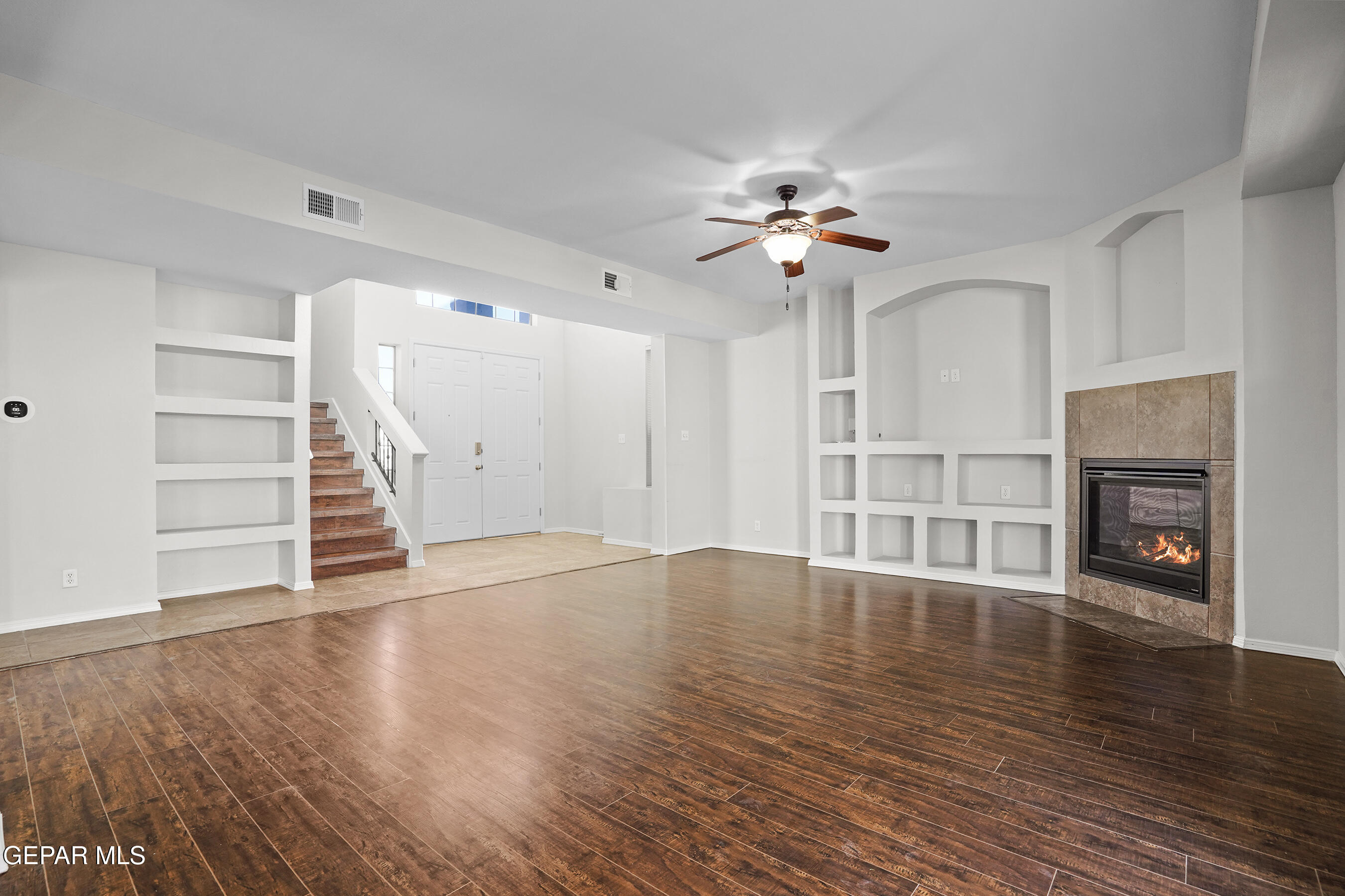 11265 Cattle Ranch Street El Paso, TX 79934 - Photo 8 of 44 wooden floor in an empty room with a fireplace